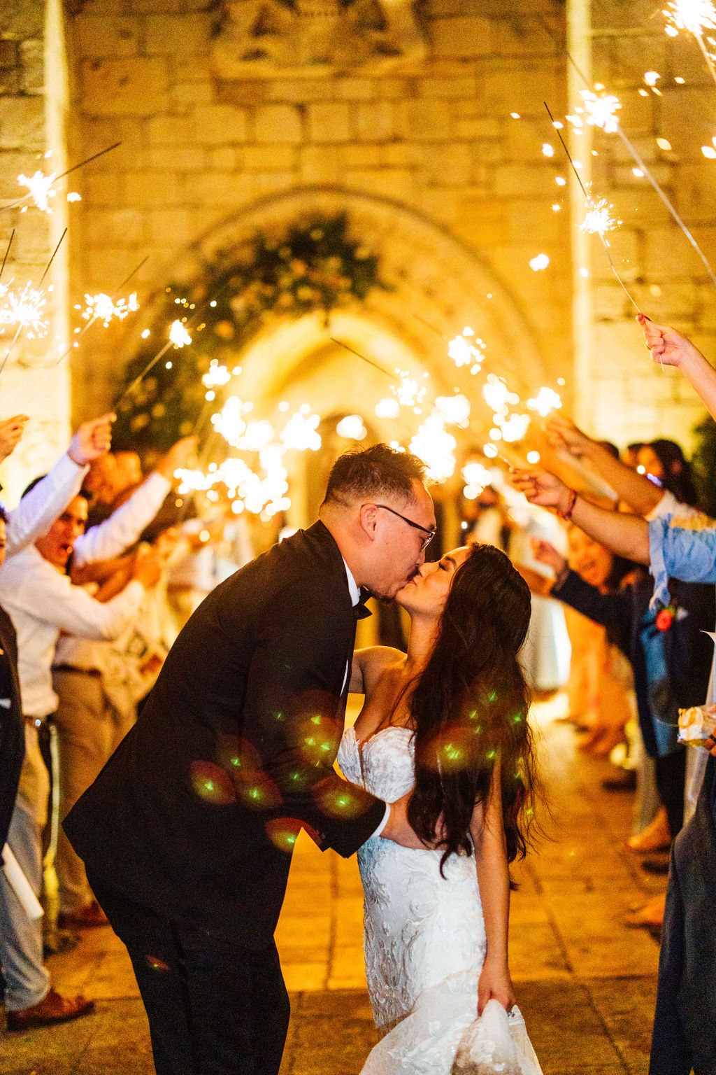 Dao and Karina sharing a kiss during their sparkler celebration
